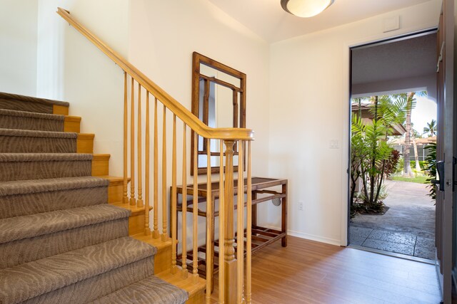 69-555 Waikoloa Beach Dr Unit 1704, Waikoloa, HI 96738 - foyer featuring stairs, wood finished floors, and baseboards