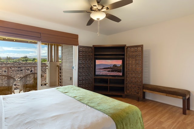 69-555 Waikoloa Beach Dr Unit 1704, Waikoloa, HI 96738 - bedroom with wood finished floors, baseboards, a ceiling fan, and access to outside