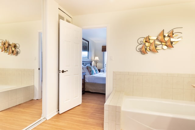 69-555 Waikoloa Beach Dr Unit 1704, Waikoloa, HI 96738 - full bathroom featuring wood finished floors, a garden tub, and connected bathroom