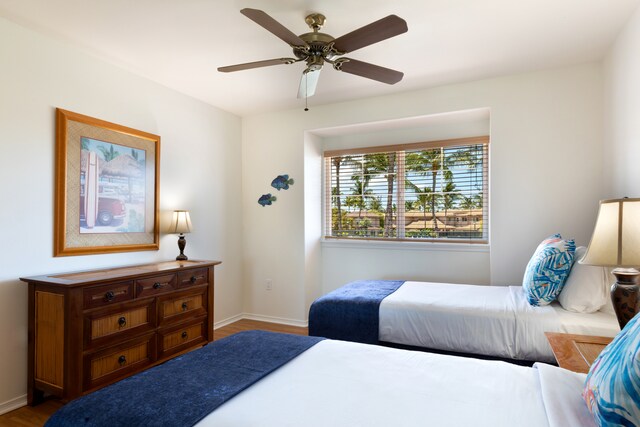 69-555 Waikoloa Beach Dr Unit 1704, Waikoloa, HI 96738 - bedroom featuring wood finished floors, baseboards, and ceiling fan