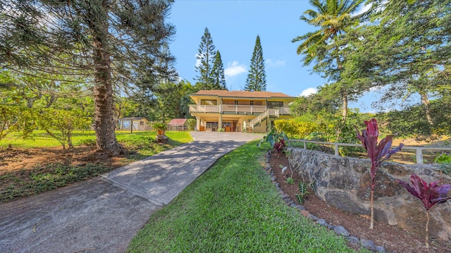 4740 Lae Rd, Kalaheo, HI 96741 - view of front of home featuring concrete driveway, a carport, covered porch, and stairs