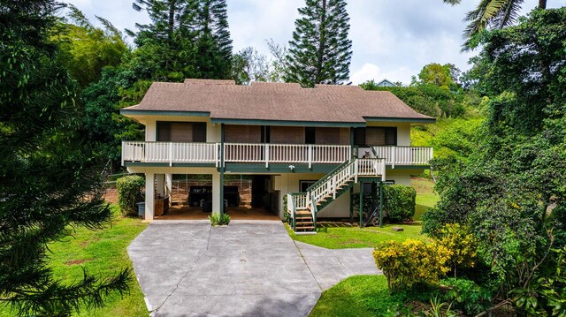 4740 Lae Rd, Kalaheo, HI 96741 - view of front facade with a carport, driveway, stairs, and a front lawn