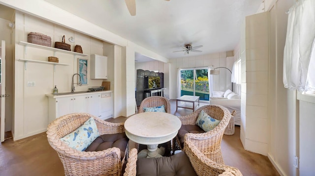 4740 Lae Rd, Kalaheo, HI 96741 - dining space with ceiling fan, a fireplace, finished concrete floors, and baseboards
