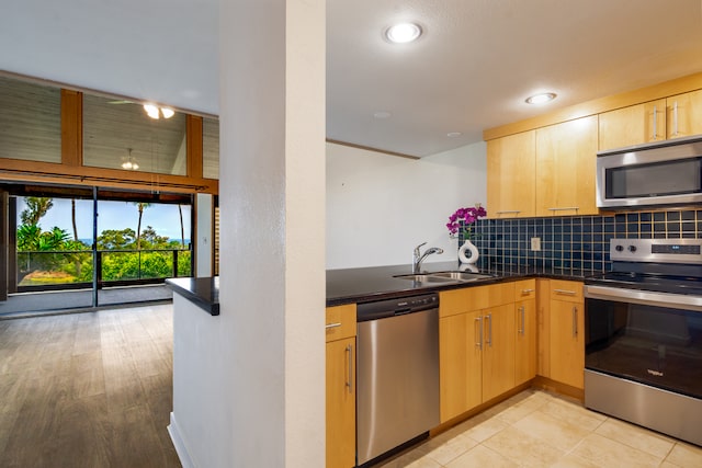 68-3840 Lua Kula St Unit D201, Waikoloa, HI 96738 - kitchen with appliances with stainless steel finishes, dark countertops, a sink, backsplash, and light brown cabinetry