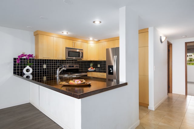 68-3840 Lua Kula St Unit D201, Waikoloa, HI 96738 - kitchen featuring appliances with stainless steel finishes, light brown cabinetry, a peninsula, tasteful backsplash, and recessed lighting
