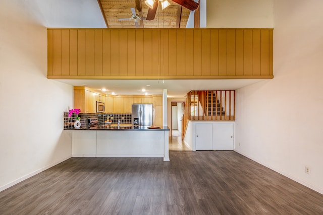 68-3840 Lua Kula St Unit D201, Waikoloa, HI 96738 - kitchen featuring appliances with stainless steel finishes, a towering ceiling, decorative backsplash, a ceiling fan, and dark wood-type flooring
