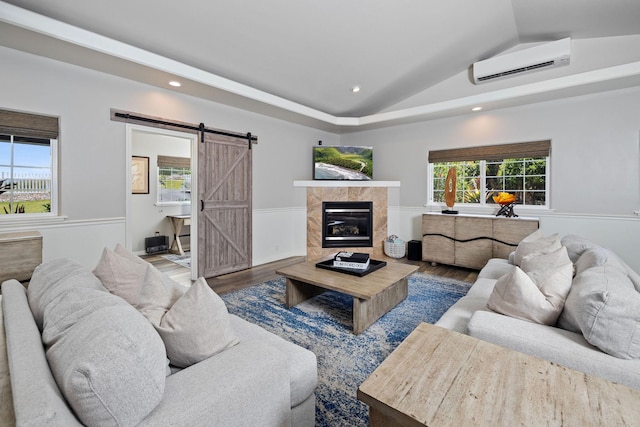 71-1876 Puu Lani Loop, Kailua-Kona, HI 96740 - living room featuring a wall unit AC, wood finished floors, a barn door, wainscoting, and lofted ceiling