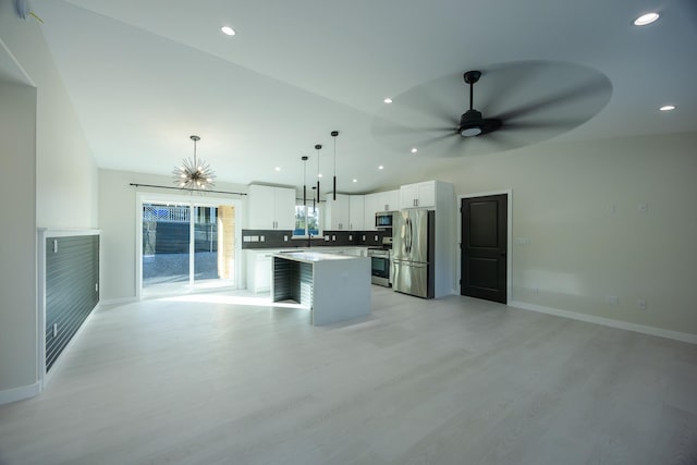 16-2100 Silveroak Dr, Pahoa, HI 96778 - unfurnished living room featuring light wood-style flooring, ceiling fan, baseboards, recessed lighting, and a chandelier