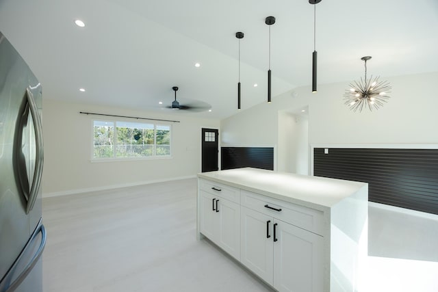 16-2100 Silveroak Dr, Pahoa, HI 96778 - kitchen with freestanding refrigerator, open floor plan, lofted ceiling, decorative light fixtures, and white cabinets