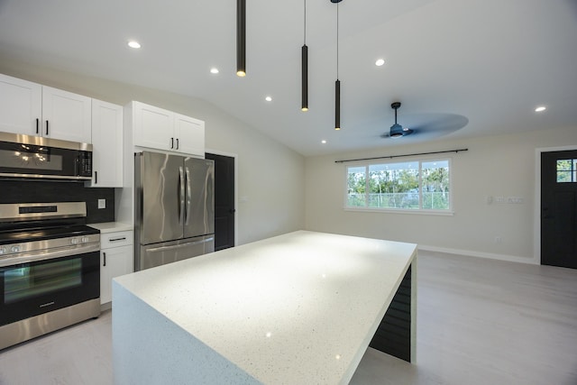 16-2100 Silveroak Dr, Pahoa, HI 96778 - kitchen featuring stainless steel appliances, white cabinetry, a ceiling fan, decorative light fixtures, and lofted ceiling