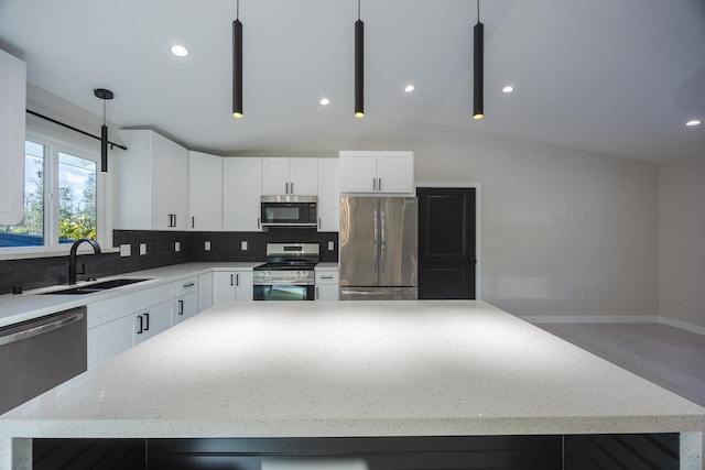 16-2100 Silveroak Dr, Pahoa, HI 96778 - kitchen featuring stainless steel appliances, a sink, decorative backsplash, vaulted ceiling, and light stone counters
