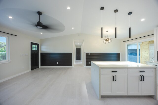 16-2100 Silveroak Dr, Pahoa, HI 96778 - kitchen featuring ceiling fan, vaulted ceiling, white cabinetry, decorative light fixtures, and light countertops