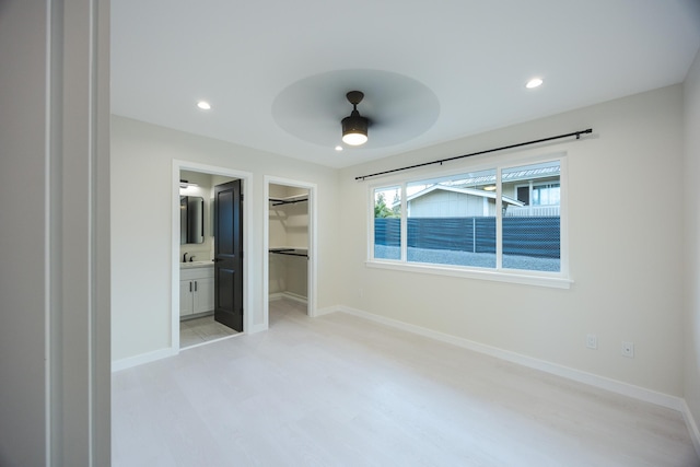 16-2100 Silveroak Dr, Pahoa, HI 96778 - unfurnished bedroom featuring light wood-type flooring, a walk in closet, baseboards, recessed lighting, and a closet