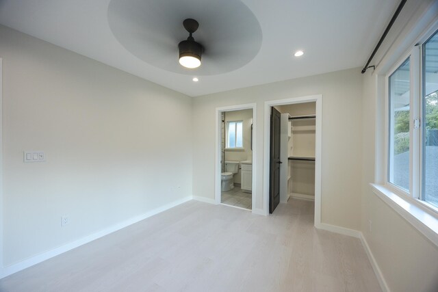 16-2100 Silveroak Dr, Pahoa, HI 96778 - unfurnished bedroom featuring light wood-style flooring, a walk in closet, baseboards, recessed lighting, and connected bathroom