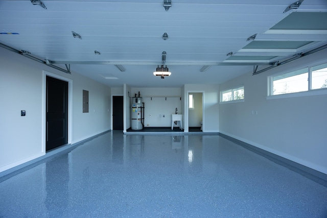 16-2100 Silveroak Dr, Pahoa, HI 96778 - garage featuring a garage door opener, baseboards, electric panel, water heater, and a sink