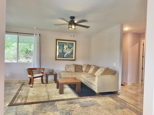 94-5763 Awa Pae Pl, Naalehu, HI 96772 - living room featuring a ceiling fan, baseboards, and stone finish flooring