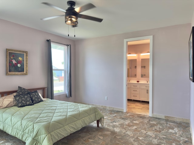94-5763 Awa Pae Pl, Naalehu, HI 96772 - bedroom with stone finish floors, baseboards, ensuite bath, ceiling fan, and a sink