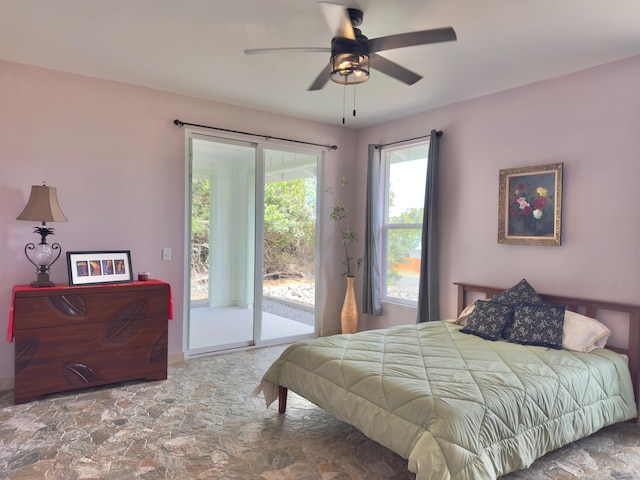 94-5763 Awa Pae Pl, Naalehu, HI 96772 - bedroom with access to outside, stone finish flooring, a ceiling fan, and baseboards