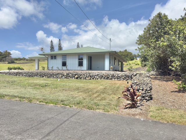 94-5763 Awa Pae Pl, Naalehu, HI 96772 - view of front facade with a front lawn, board and batten siding, and metal roof