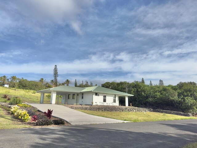 94-5763 Awa Pae Pl, Naalehu, HI 96772 - view of front of house with metal roof and driveway