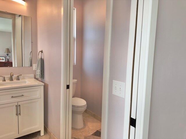 94-5763 Awa Pae Pl, Naalehu, HI 96772 - bathroom featuring toilet, vanity, and baseboards