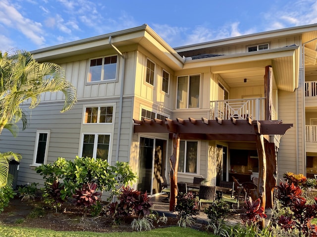 68-180 Waikoloa Beach Dr Unit P4, Waikoloa, HI 96738 - back of house featuring a balcony, board and batten siding, and a patio