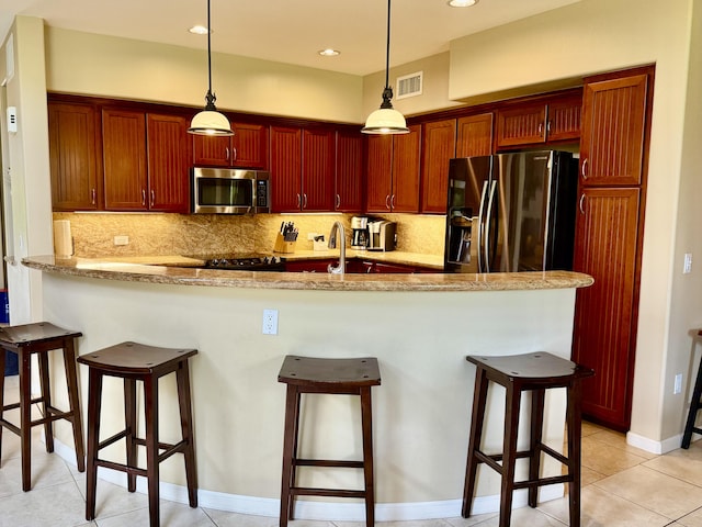 68-180 Waikoloa Beach Dr Unit P4, Waikoloa, HI 96738 - kitchen featuring appliances with stainless steel finishes, a kitchen bar, backsplash, pendant lighting, and recessed lighting
