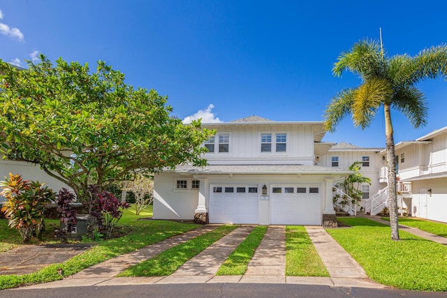 4771 Pepelani Lp Unit 921, Princeville, HI 96722 - view of front facade with concrete driveway, an attached garage, a front yard, and stairway
