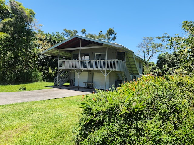 15-2687 Kaku St, Pahoa, HI 96778 - view of front of house with stairway, an attached garage, a front yard, and concrete driveway