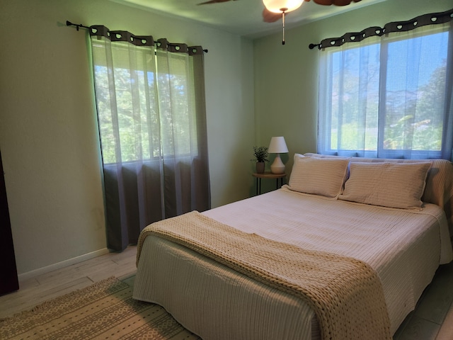 15-2687 Kaku St, Pahoa, HI 96778 - bedroom featuring multiple windows, light wood-type flooring, baseboards, and a ceiling fan