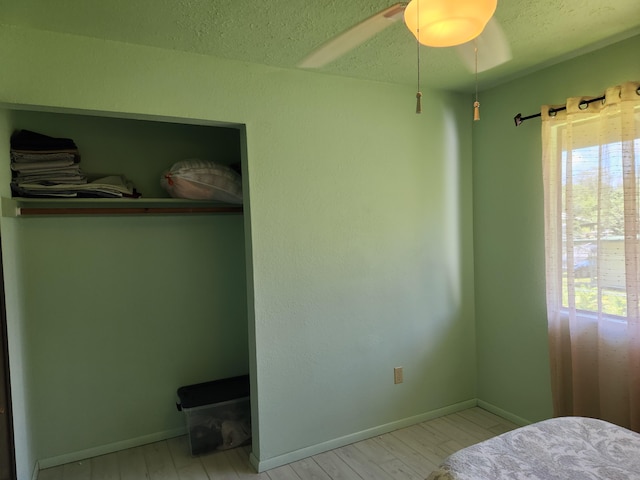 15-2687 Kaku St, Pahoa, HI 96778 - bedroom featuring baseboards, wood finished floors, a textured ceiling, and ceiling fan