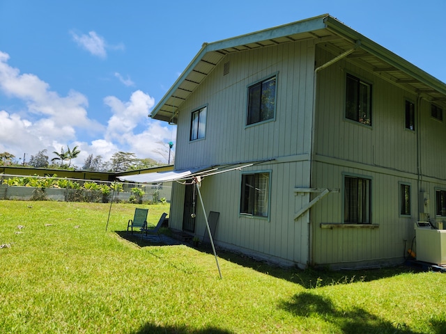 15-2687 Kaku St, Pahoa, HI 96778 - view of property exterior with a lawn and central air condition unit