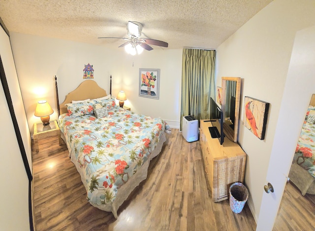 2191 Kihei Rd Unit 3308, Kihei, HI 96753 - bedroom featuring wood finished floors, a textured ceiling, and a ceiling fan