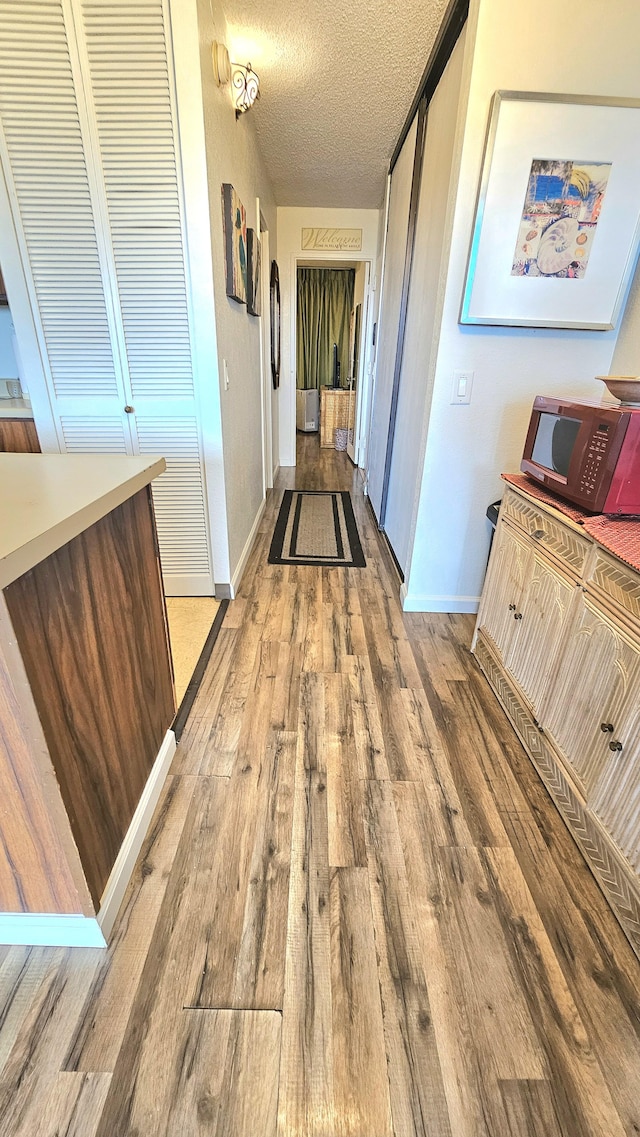 2191 Kihei Rd Unit 3308, Kihei, HI 96753 - hallway featuring wood finished floors and a textured ceiling