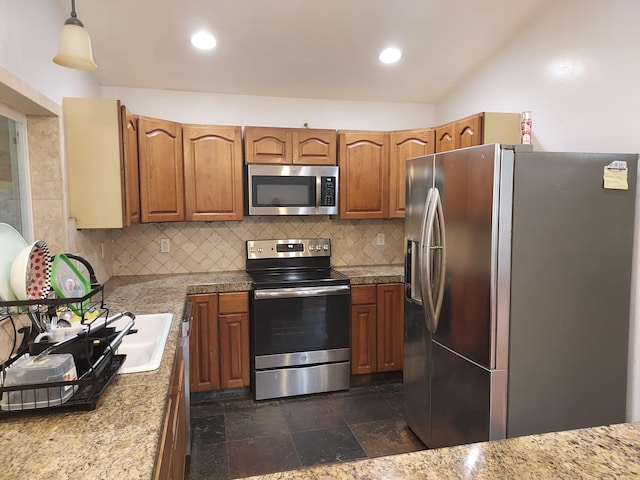 14-3431 Seadrift Rd, Pahoa, HI 96778 - kitchen featuring stainless steel appliances, decorative backsplash, brown cabinetry, decorative light fixtures, and vaulted ceiling