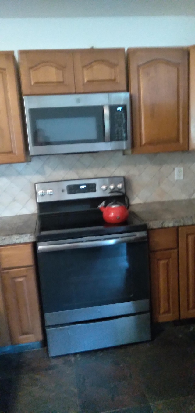 14-3431 Seadrift Rd, Pahoa, HI 96778 - kitchen featuring appliances with stainless steel finishes, backsplash, and brown cabinets