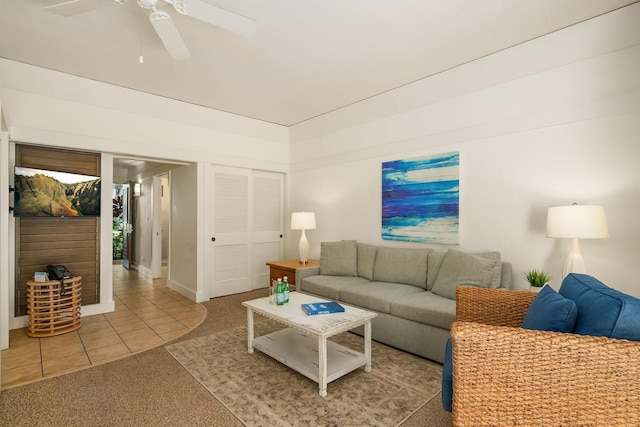 2253 Poipu Rd Unit 440, Koloa, HI 96756 - tiled living room with a ceiling fan, carpet flooring, and baseboards
