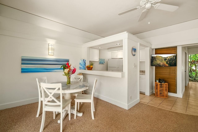 2253 Poipu Rd Unit 440, Koloa, HI 96756 - dining space with baseboards, light colored carpet, a ceiling fan, and light tile patterned floors