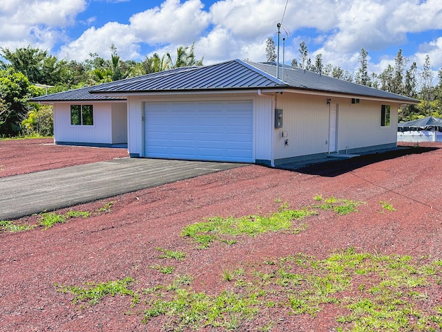 15-1622 3rd Ave, Keaau, HI 96749 - view of front of house with metal roof, asphalt driveway, and a garage