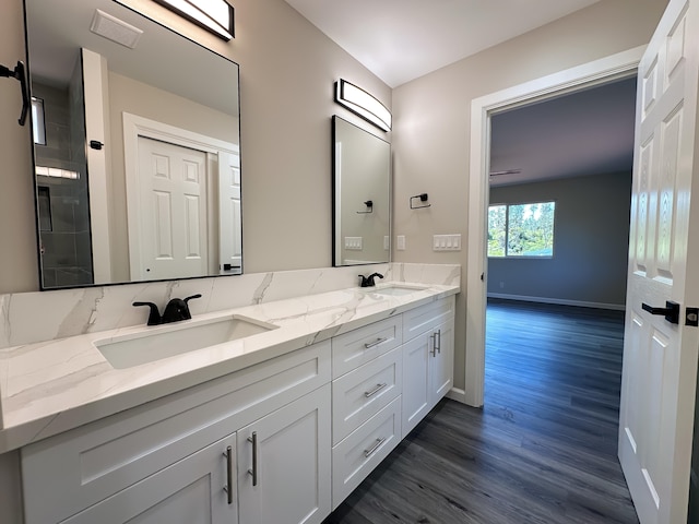 15-1622 3rd Ave, Keaau, HI 96749 - bathroom with double vanity, wood finished floors, and baseboards
