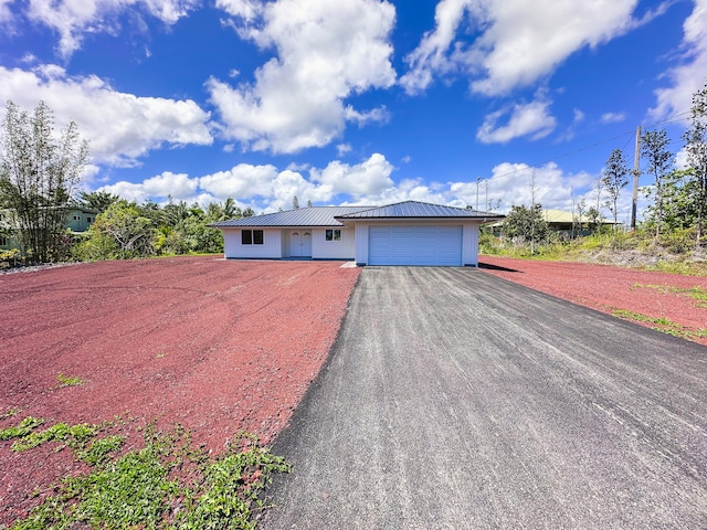 15-1622 3rd Ave, Keaau, HI 96749 - ranch-style house featuring driveway, an attached garage, and metal roof