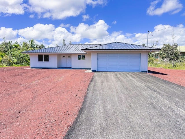 15-1622 3rd Ave, Keaau, HI 96749 - view of front of house featuring driveway, an attached garage, and metal roof