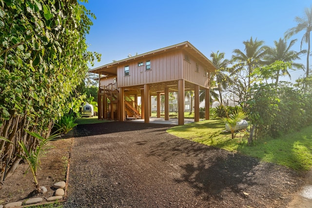 5-7084 Kuhio Hwy, Hanalei, HI 96714 - rear view of property with a carport, stairway, and dirt driveway