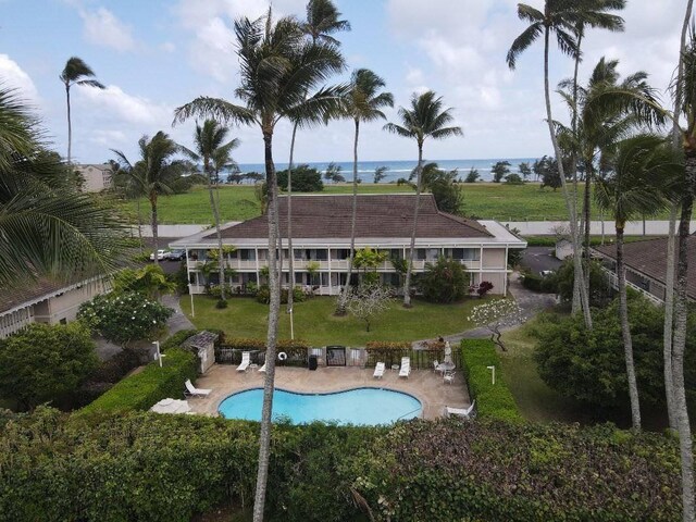 525 Aleka Lp Unit J2, Kapaa, HI 96746 - back of house featuring a patio area, a lawn, and a community pool