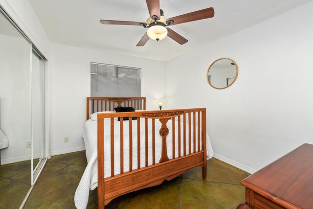 68-1884 Kaupapa Pl, Waikoloa, HI 96738 - bedroom featuring a closet, baseboards, a ceiling fan, and concrete flooring