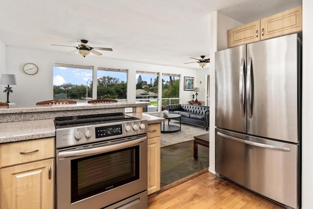68-1884 Kaupapa Pl, Waikoloa, HI 96738 - kitchen with appliances with stainless steel finishes, a ceiling fan, light brown cabinetry, and open floor plan