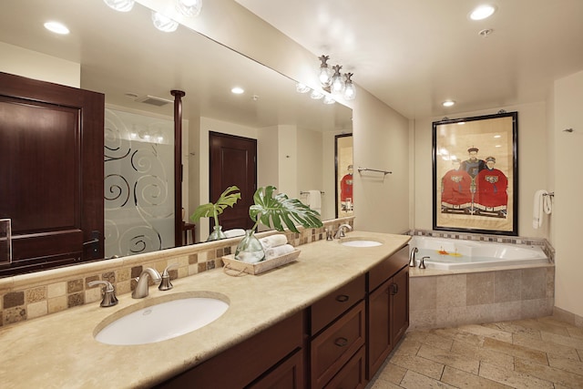 4-820 Kuhio Hwy Unit C106, Kapaa, HI 96746 - bathroom featuring stone tile floors, a bath, double vanity, recessed lighting, and tasteful backsplash