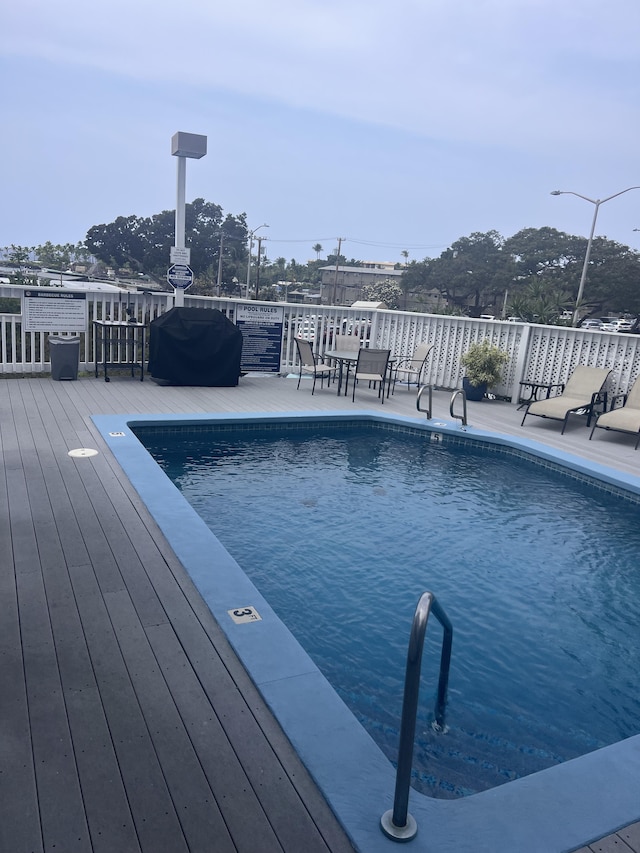 75-5680 Kuakini Hwy Unit 112, Kailua-Kona, HI 96740 - view of swimming pool featuring a wooden deck and outdoor dining area