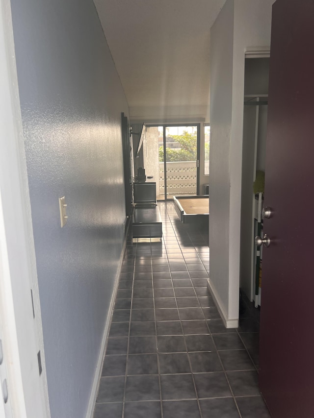 75-5680 Kuakini Hwy Unit 112, Kailua-Kona, HI 96740 - hall featuring baseboards and dark tile patterned flooring