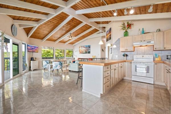 87-3216 Ama Rd, Captain Cook, HI 96704 - kitchen with white electric range oven, under cabinet range hood, wood ceiling, a peninsula, and decorative backsplash